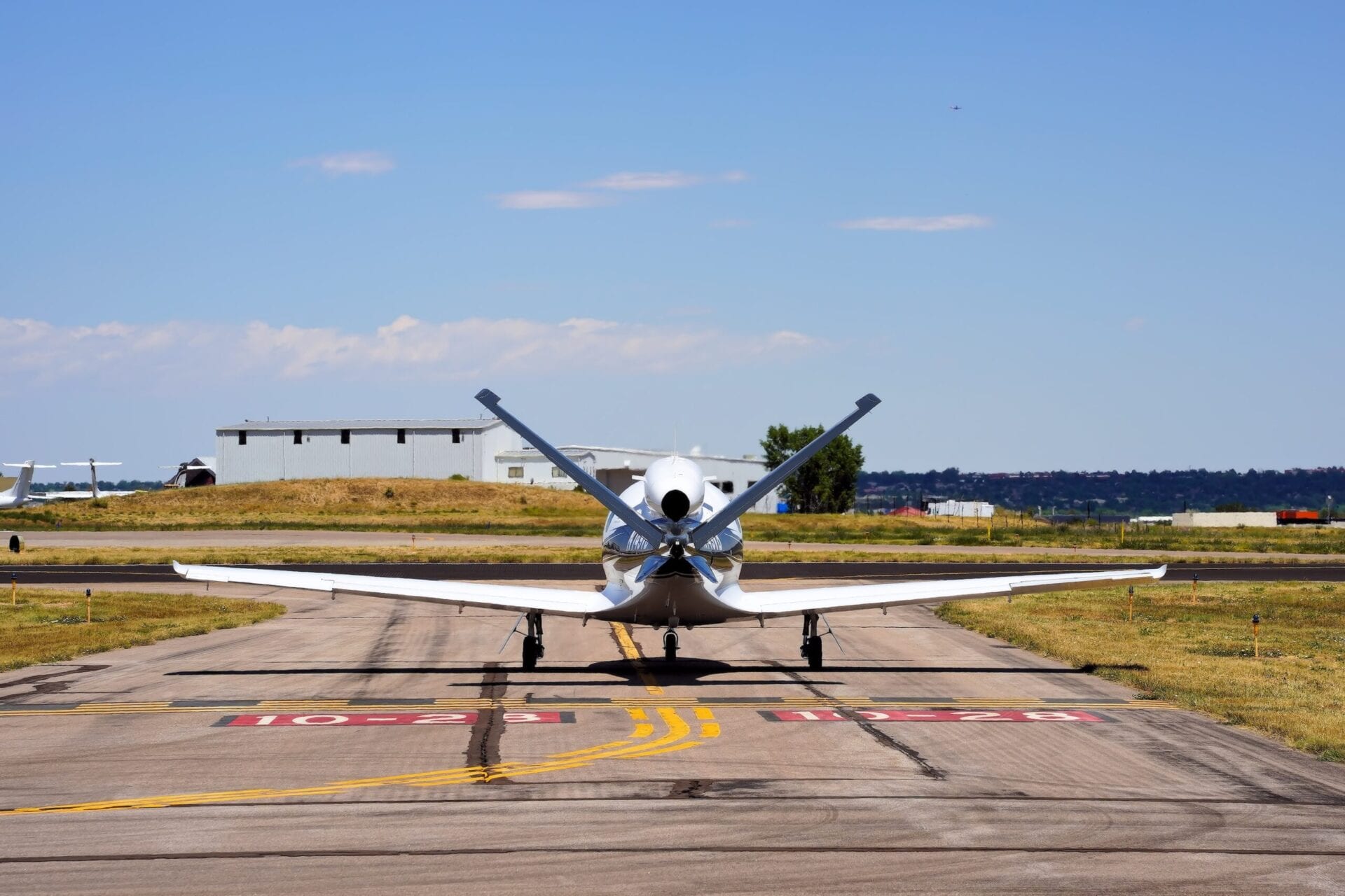 Rear view of Cirrus SF50 vision jet taxiing at airport