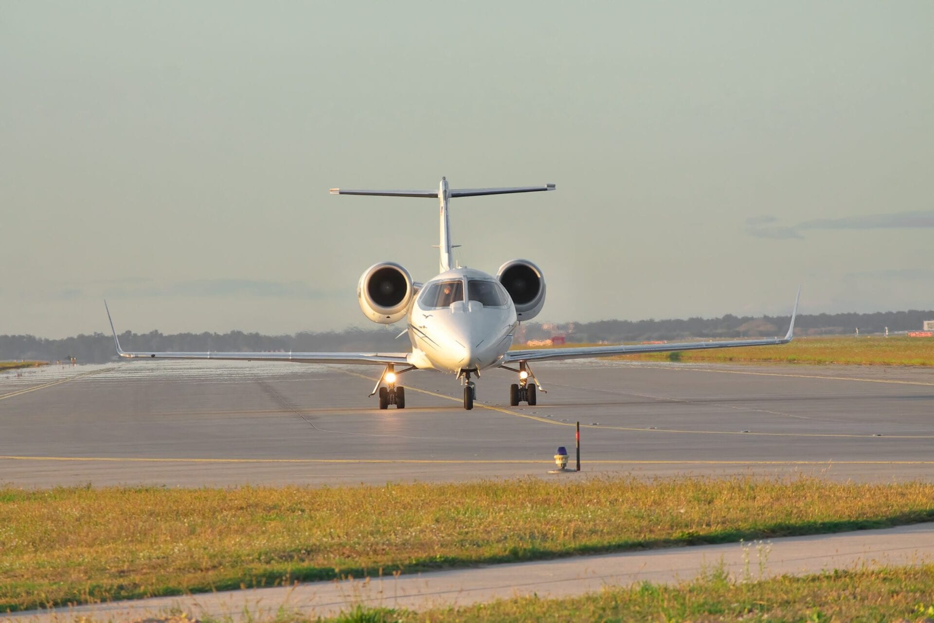 Business jet taxiing along the runway front on