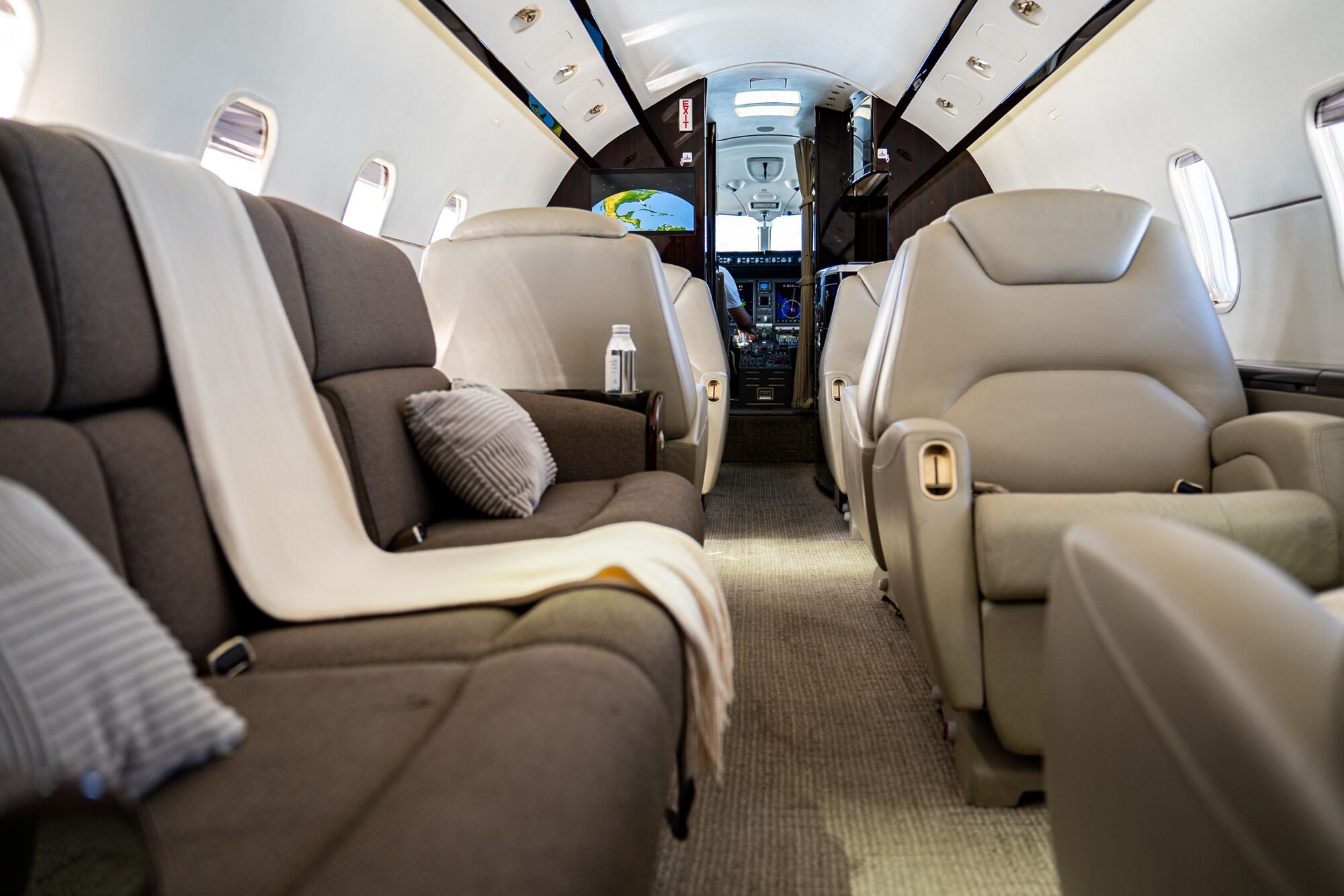 The cabin of a CRAFT Challenger, looking forward past the club seats to the flight deck