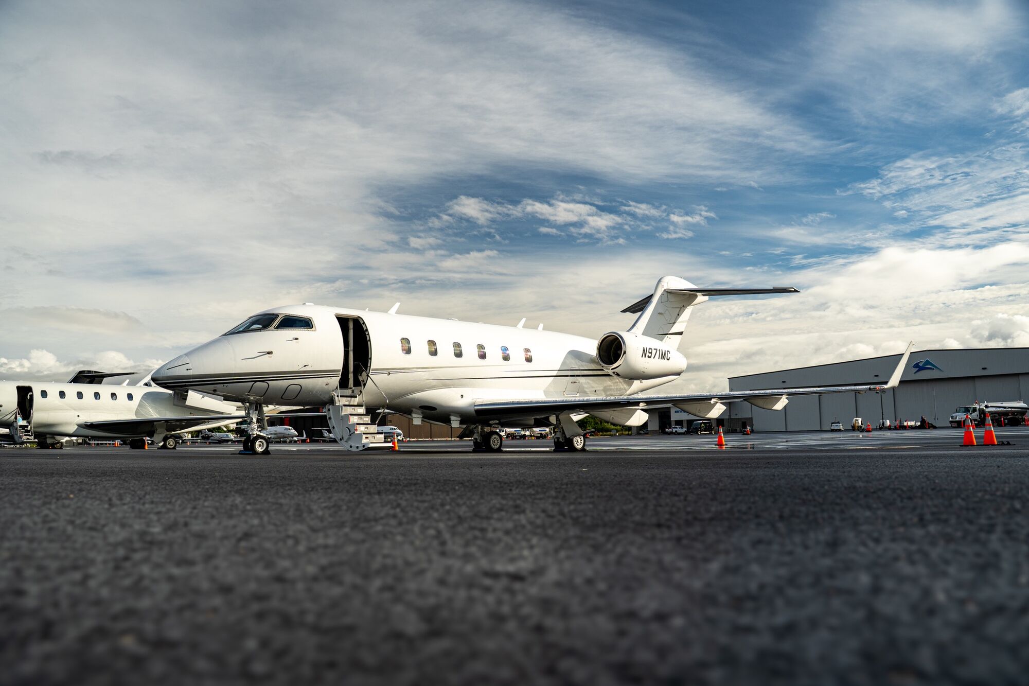 CRAFT Challenger 300 N971MC on the ramp under a cloudy sky