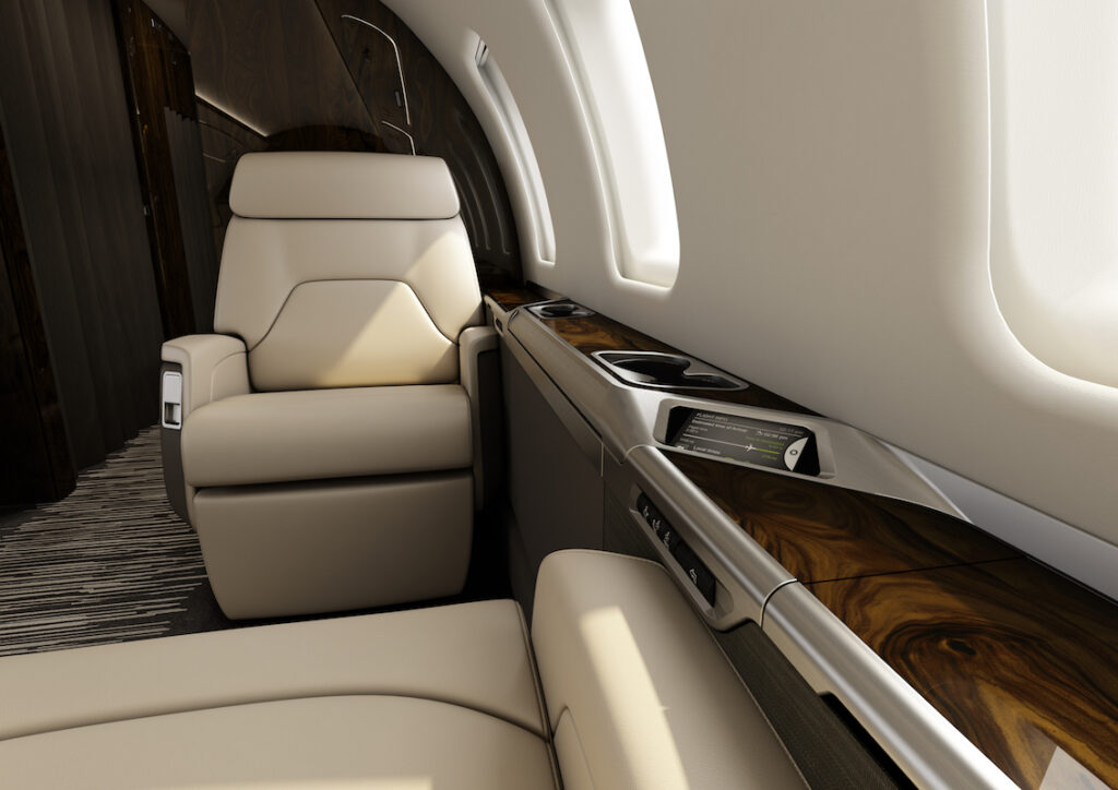 Bombardier Challenger 650 Interior angled touchscreen, perspective of of sitting in seat