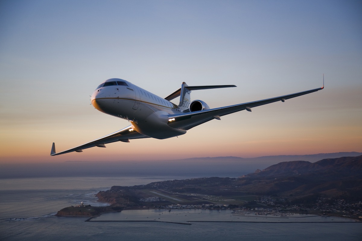 Bombardier Global 6000 Exterior takeoff at sunset with mountains behind