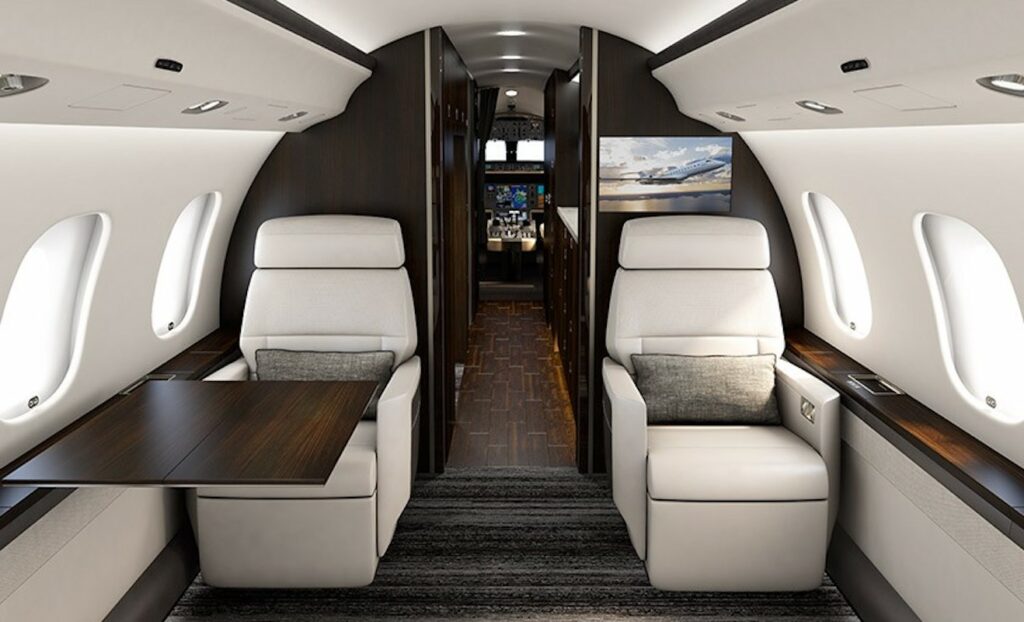 Bombardier Global 6000 Interior white leather seats infront of galley and cockpit behind
