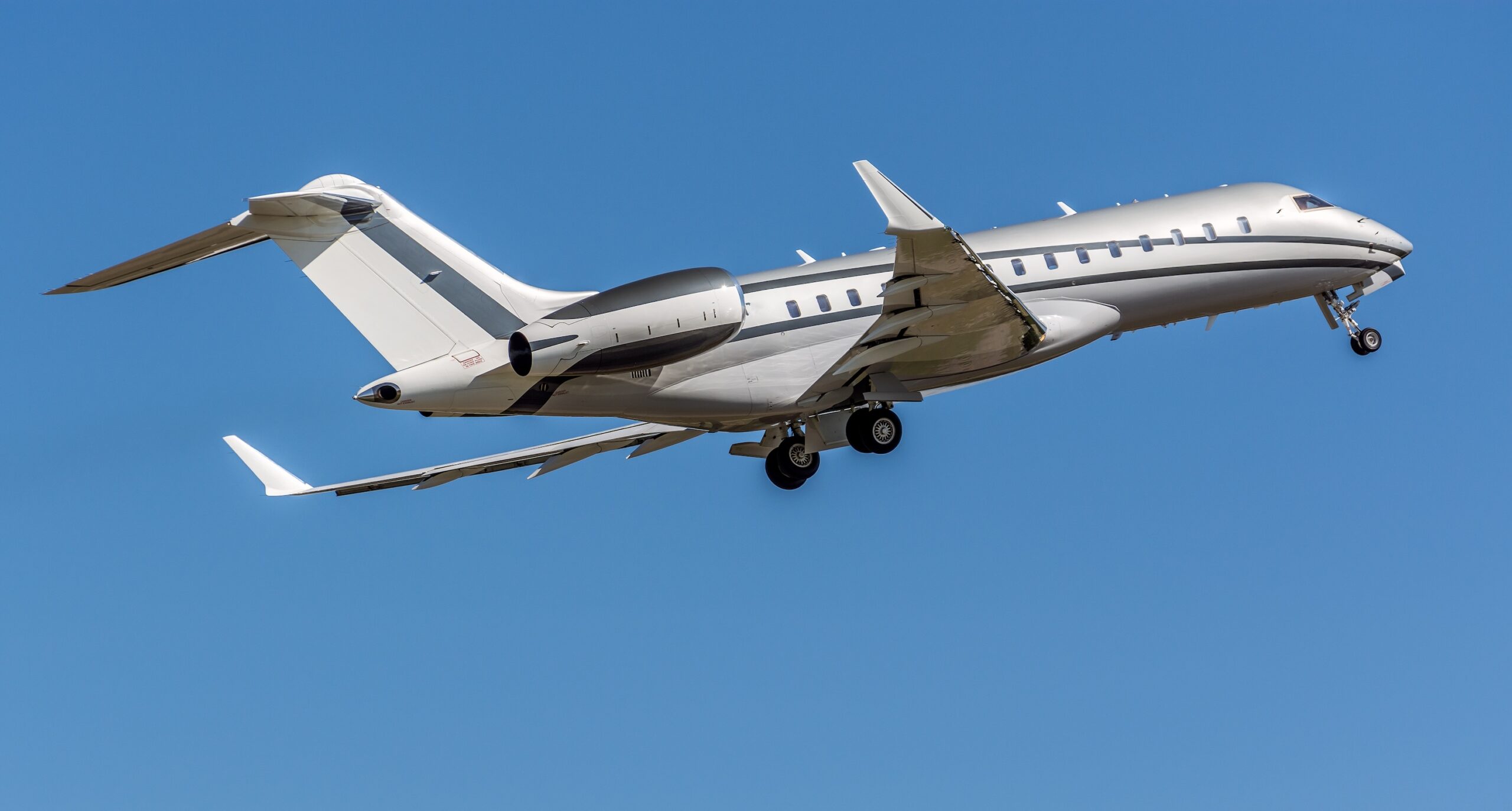 Bombardier Global 6000 taking off from airport while wheels retract